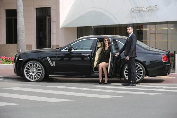 Luxury Vehicle Chauffeur Service Elite Vehicle Cabin Workspace Highlighting Tailored Luxury Leathers And Rear Command Entertainment Layout